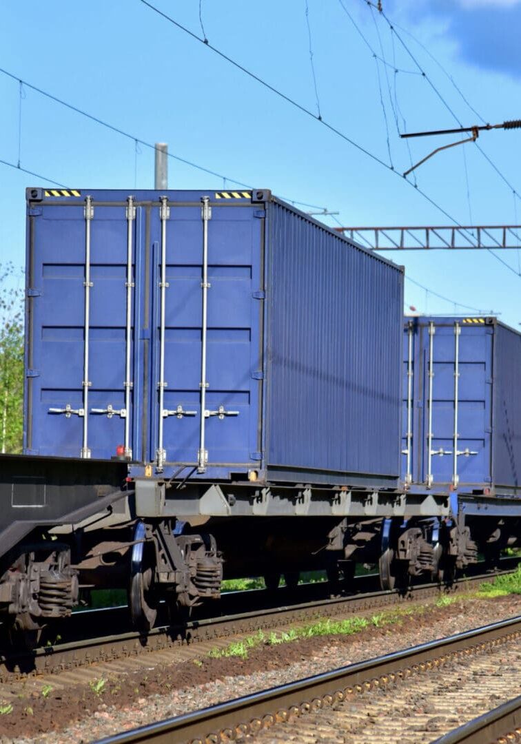Cargo Containers Transportation On Freight Train By Railway. Intermodal Container On Train Car Freight train with colorful shipping containers.